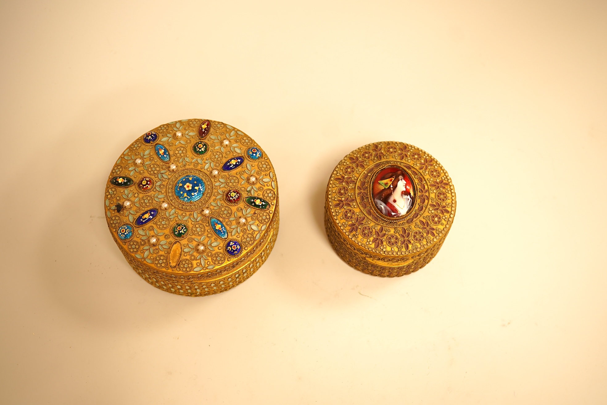 Two Limoges enamel mounted gilt filigree work circular boxes, largest 8cm diameter